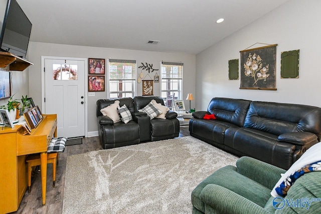 living room featuring lofted ceiling and dark hardwood / wood-style floors