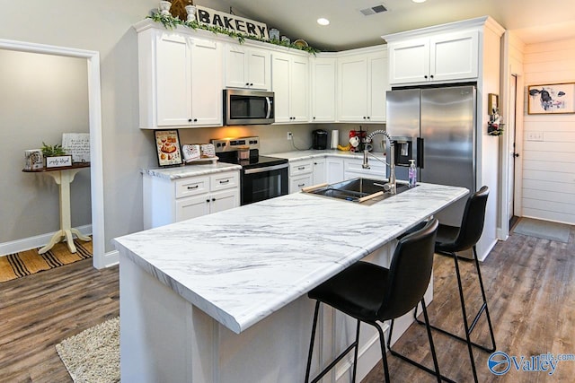 kitchen featuring white cabinetry, appliances with stainless steel finishes, and sink