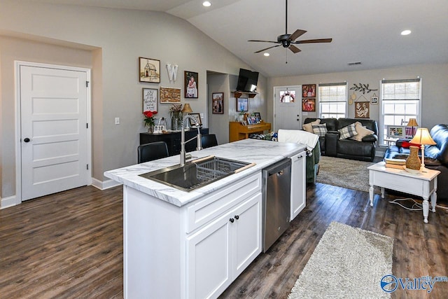 kitchen featuring lofted ceiling, sink, dishwasher, white cabinetry, and a kitchen island with sink