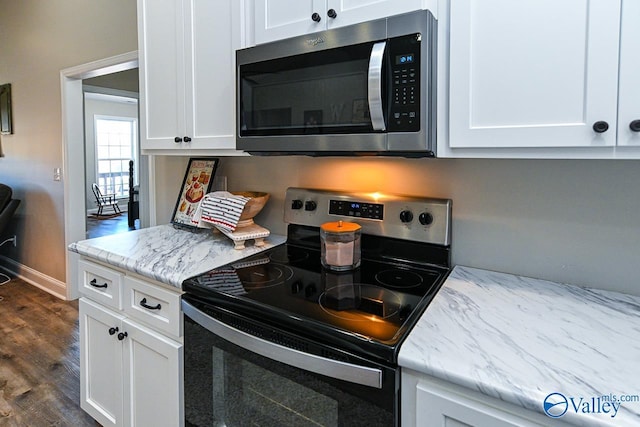 kitchen with white cabinetry, dark hardwood / wood-style flooring, and stainless steel appliances