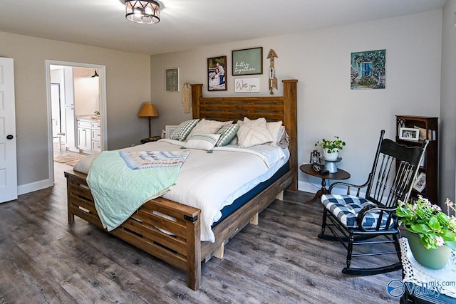 bedroom with dark hardwood / wood-style floors and connected bathroom