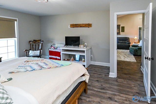 bedroom with dark hardwood / wood-style floors