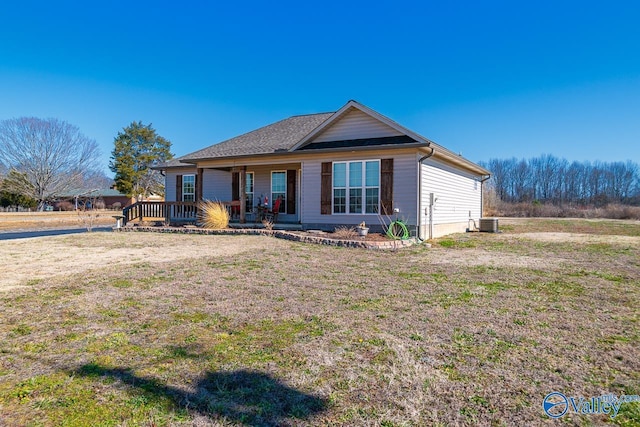 view of front of property featuring a porch, a front yard, and central air condition unit