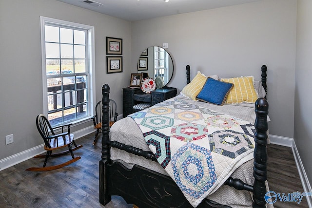 bedroom with dark hardwood / wood-style floors