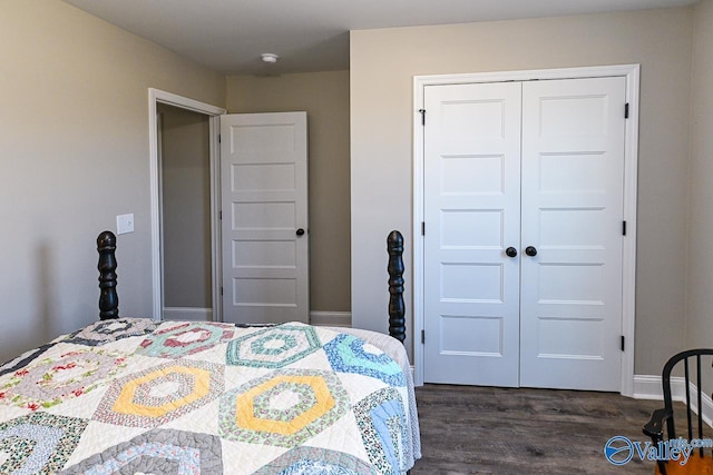 bedroom with dark wood-type flooring and a closet