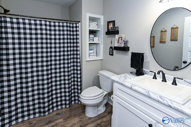 bathroom with hardwood / wood-style flooring, vanity, and toilet