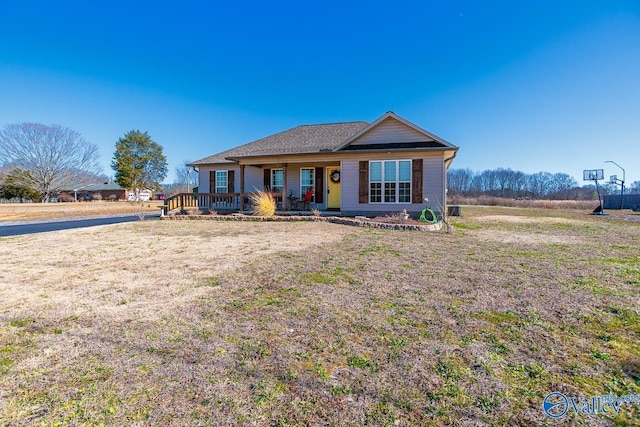 ranch-style house featuring a wooden deck and a front yard