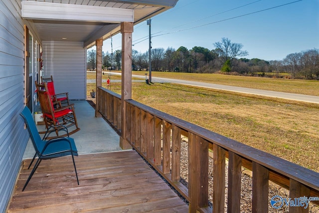 deck featuring a porch and a yard