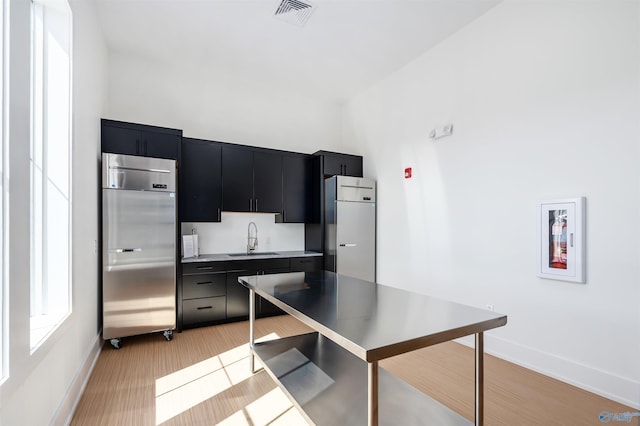 152 Knockash Hl, Madison, AL 35756 - kitchen with dark cabinets, built in fridge, fridge, a sink, and baseboards