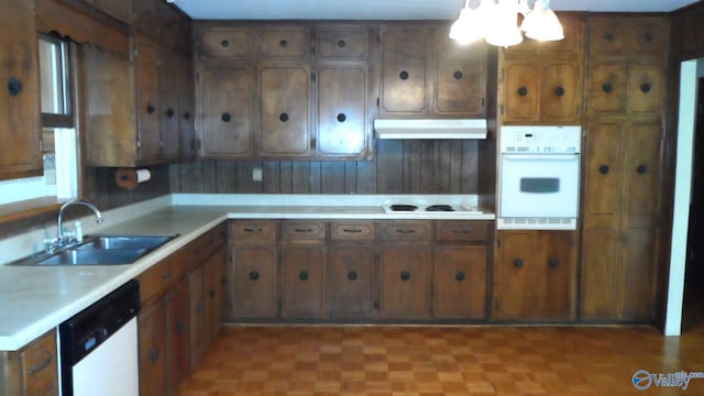 kitchen with sink, white appliances, ventilation hood, and light parquet flooring