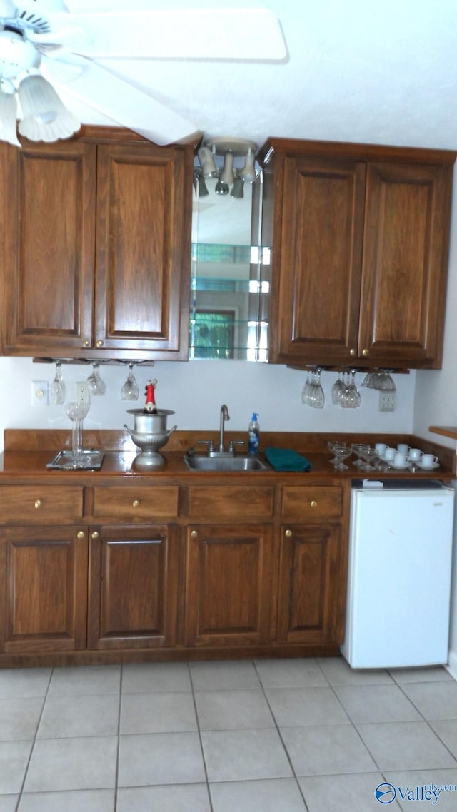 kitchen featuring sink, dishwasher, and light tile patterned floors