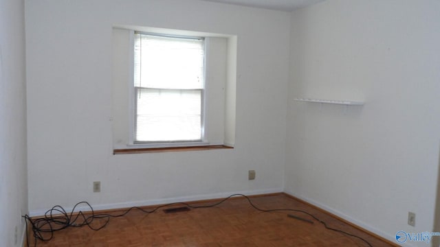 unfurnished room with parquet floors