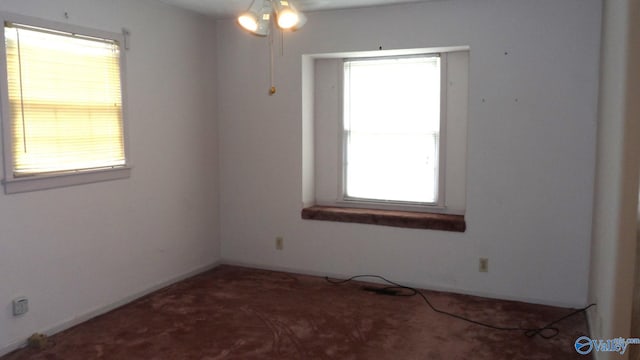 carpeted empty room featuring ceiling fan