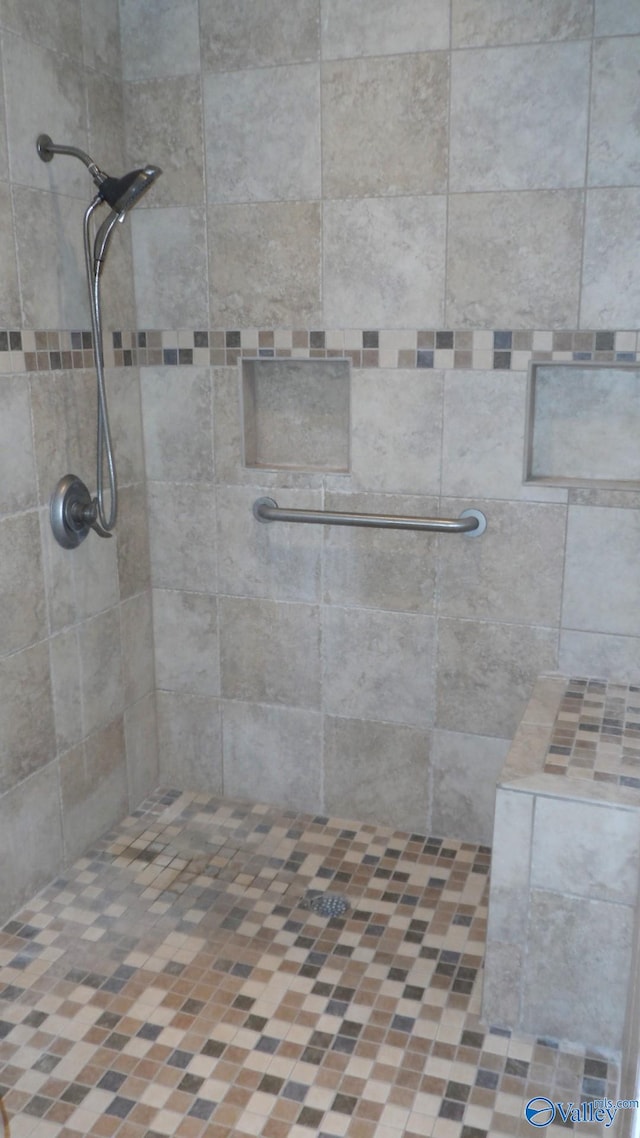 bathroom with a tile shower