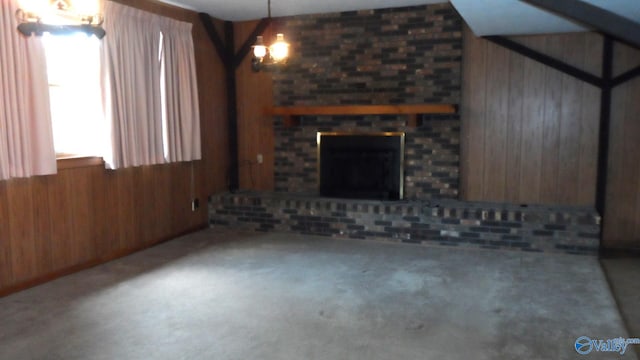 unfurnished living room with a brick fireplace and wooden walls