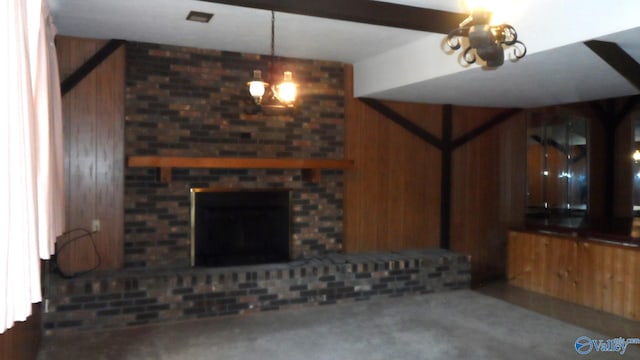 unfurnished living room featuring wood walls, carpet floors, and a brick fireplace