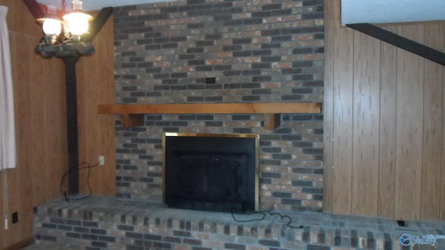 room details with an inviting chandelier and a brick fireplace