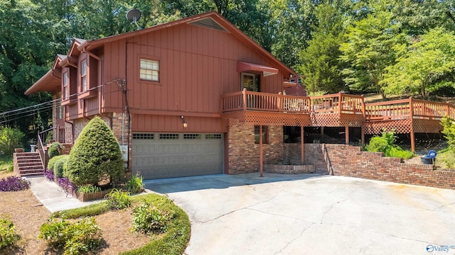 view of property featuring a deck and a garage