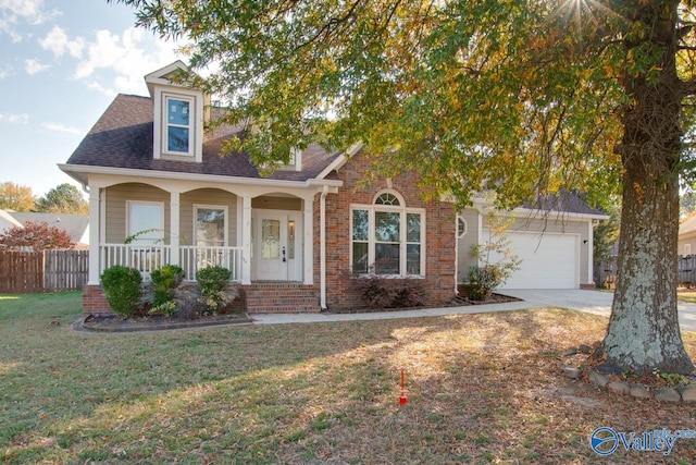 view of front of home with a front lawn, a garage, and a porch