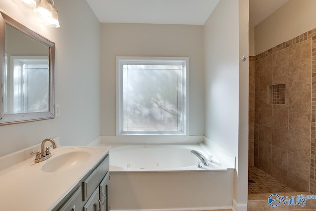 bathroom featuring plus walk in shower and vanity