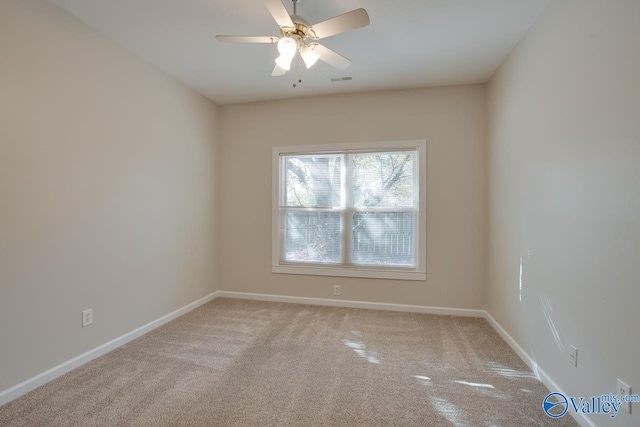 carpeted spare room featuring ceiling fan