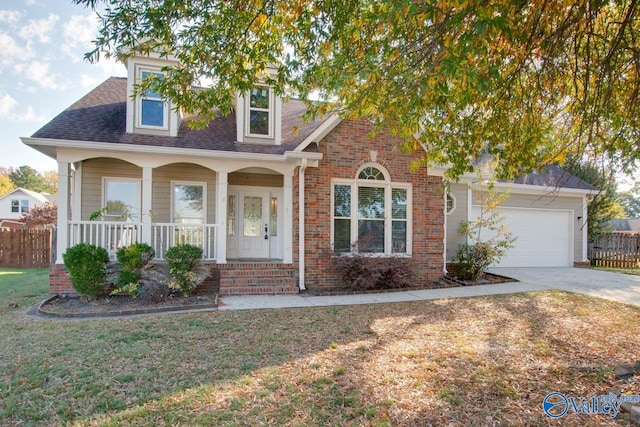 view of front facade with a garage, a front yard, and a porch