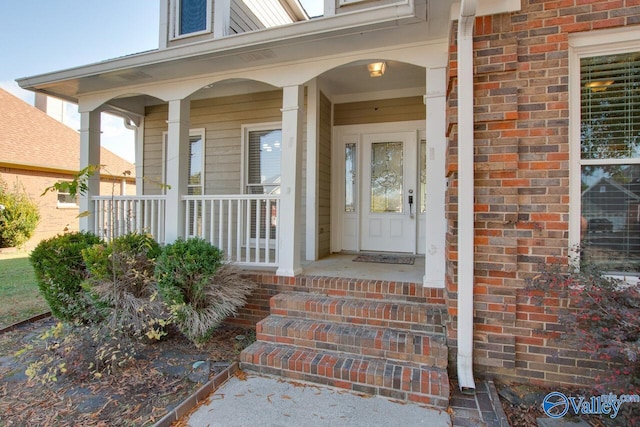 view of exterior entry with covered porch