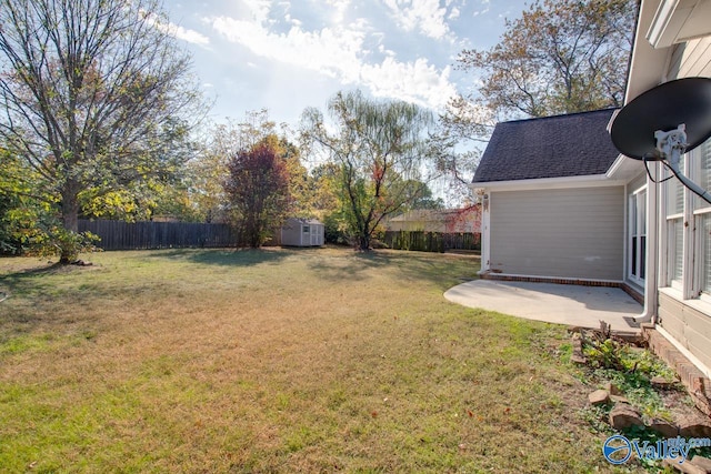 view of yard with a patio and a storage unit