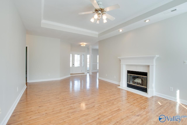 107 Palomino Ct, Madison, AL 35758 - unfurnished living room with a tray ceiling, ceiling fan, light wood-type flooring, a fireplace, and recessed lighting