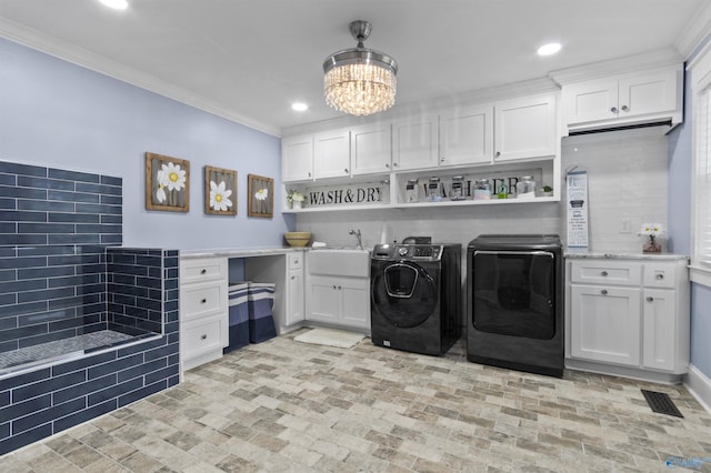 855 Haynes Rd NE, Arab, AL 35016 - washroom with washing machine and clothes dryer, brick patterned floors, crown molding, a chandelier, and cabinet space