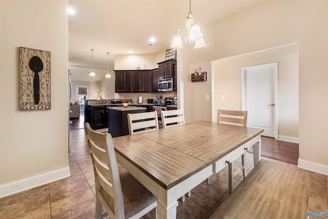 tiled dining space featuring an inviting chandelier