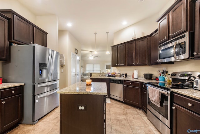 kitchen featuring appliances with stainless steel finishes, light tile patterned flooring, a kitchen island, ceiling fan, and decorative light fixtures