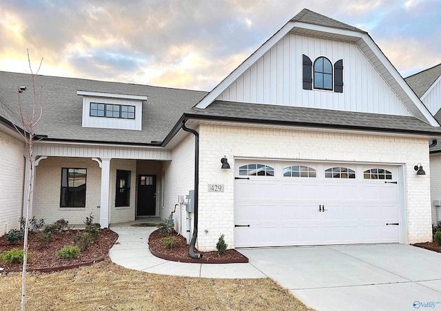 view of front facade with a garage and covered porch