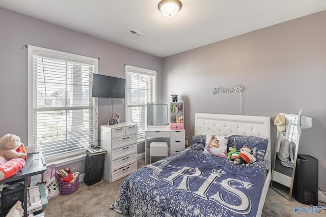 carpeted bedroom featuring visible vents