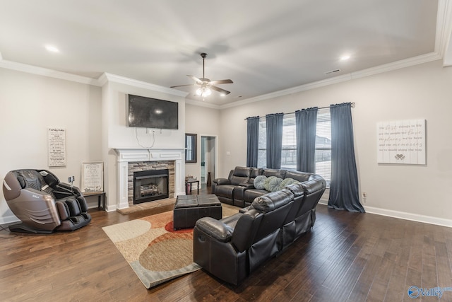 living room with crown molding, dark wood-type flooring, a fireplace, and baseboards