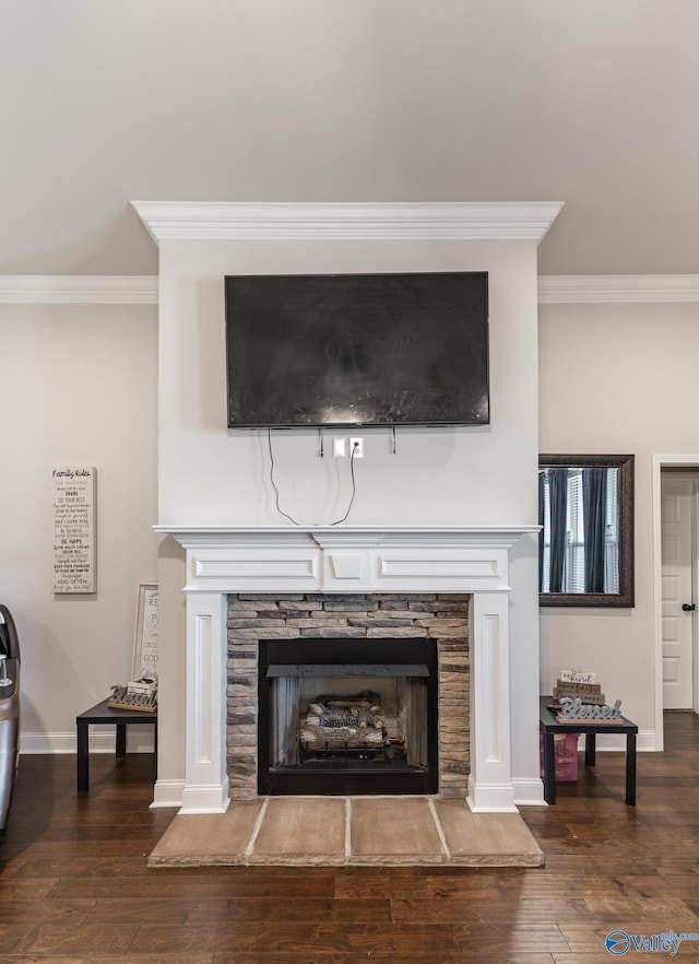 interior details with baseboards, a fireplace, ornamental molding, and wood finished floors