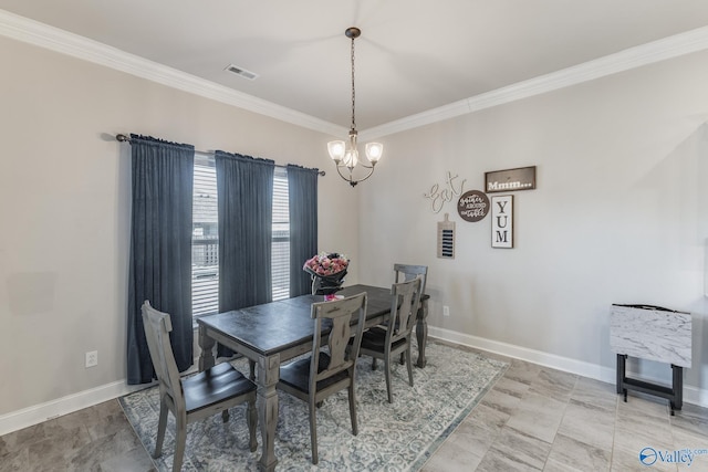 dining room with crown molding, baseboards, and an inviting chandelier