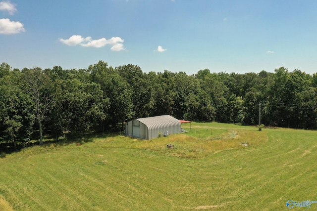 view of yard featuring a garage, a pole building, and an outdoor structure