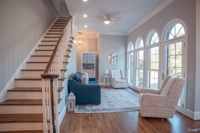 living room with wood-type flooring, crown molding, plenty of natural light, and ceiling fan