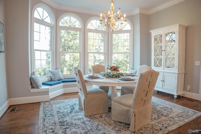 dining room featuring an inviting chandelier, wood-type flooring, crown molding, and a healthy amount of sunlight