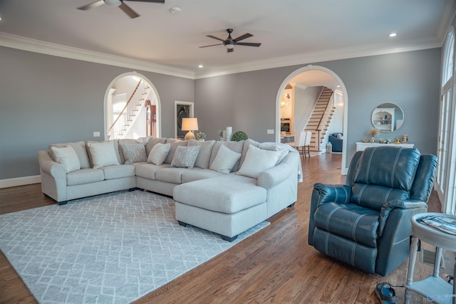 living room with ornamental molding, ceiling fan, and hardwood / wood-style floors