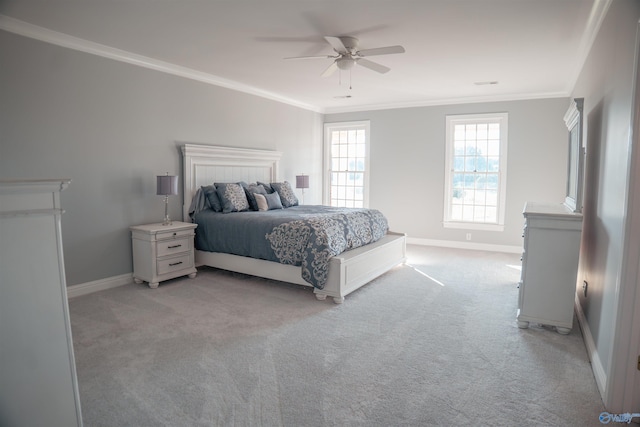 carpeted bedroom with crown molding and ceiling fan