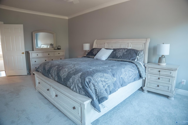 bedroom with crown molding and light colored carpet