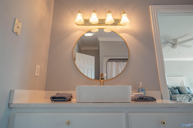 bathroom with crown molding, vanity, and ceiling fan