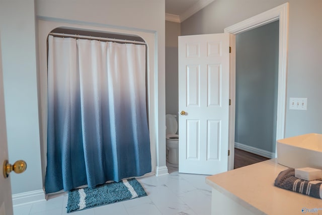 bathroom with toilet, tile patterned floors, and crown molding