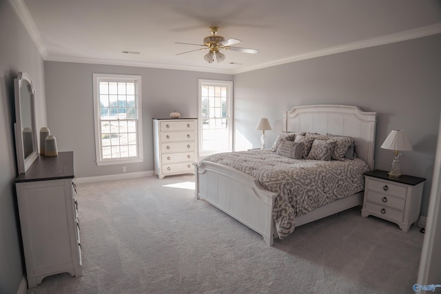 bedroom with ornamental molding, light colored carpet, and ceiling fan