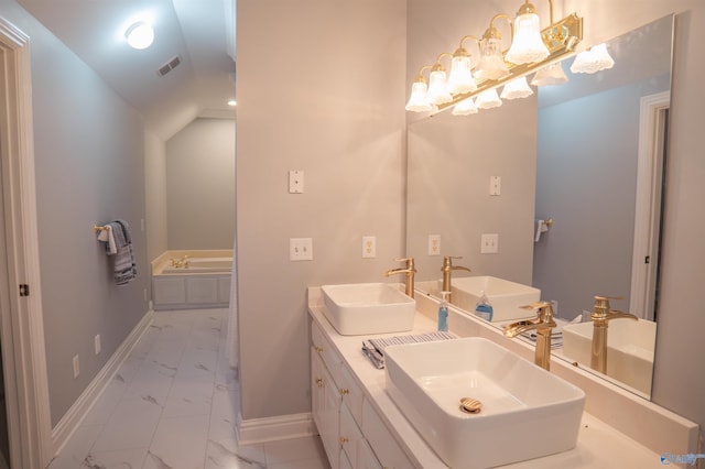 bathroom featuring double vanity, lofted ceiling, tile patterned floors, and a bath