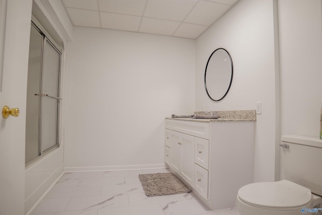 full bathroom featuring vanity, enclosed tub / shower combo, a paneled ceiling, toilet, and tile patterned flooring