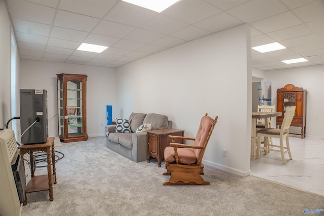 tiled living room with a paneled ceiling