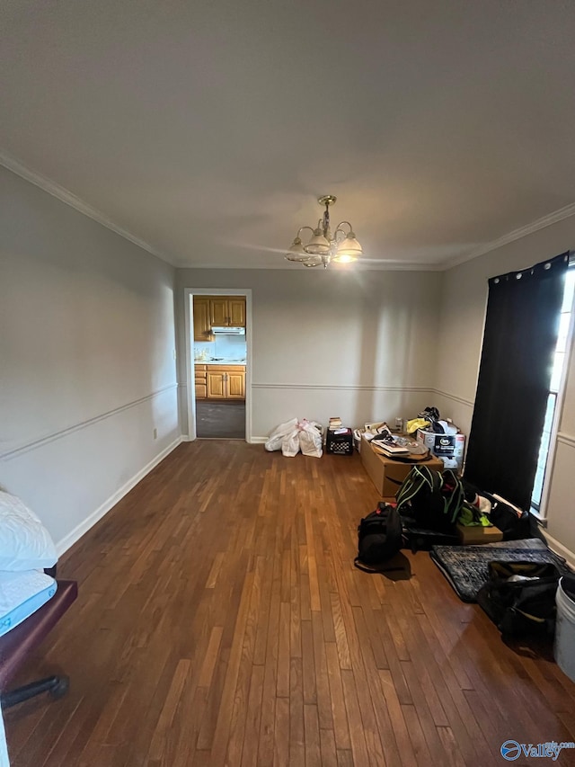 unfurnished dining area with baseboards, ornamental molding, and dark wood-style flooring